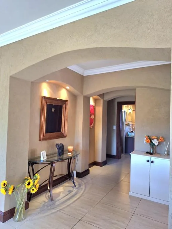 Elegant hallway with arched ceilings, console table, and fresh flower arrangements