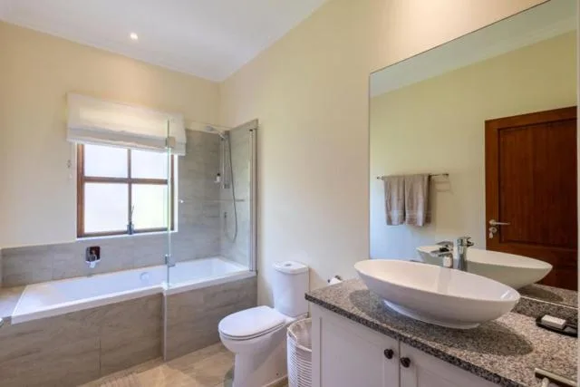 Modern bathroom with double vanity, soaking tub, and walk-in shower