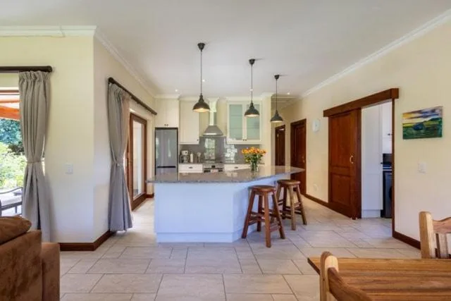 Modern open-plan kitchen with island counter and pendant lighting fixtures