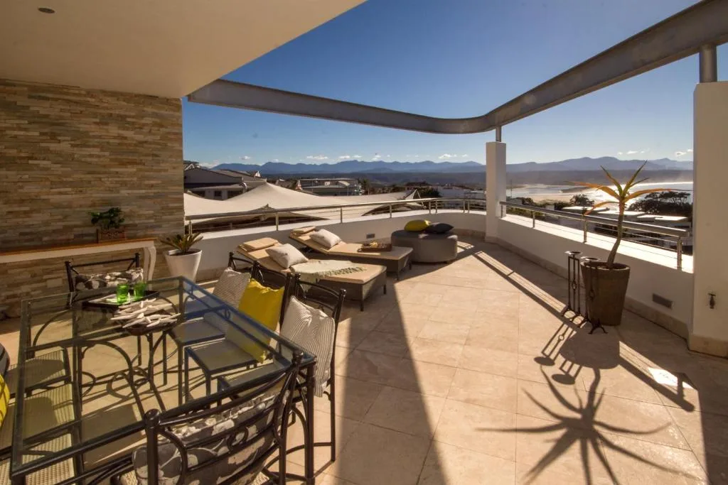 Spacious rooftop terrace with loungers, mountain and lagoon views