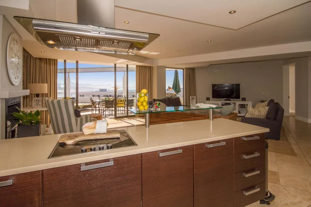 Modern kitchen with island counter overlooking ocean views and lounge area