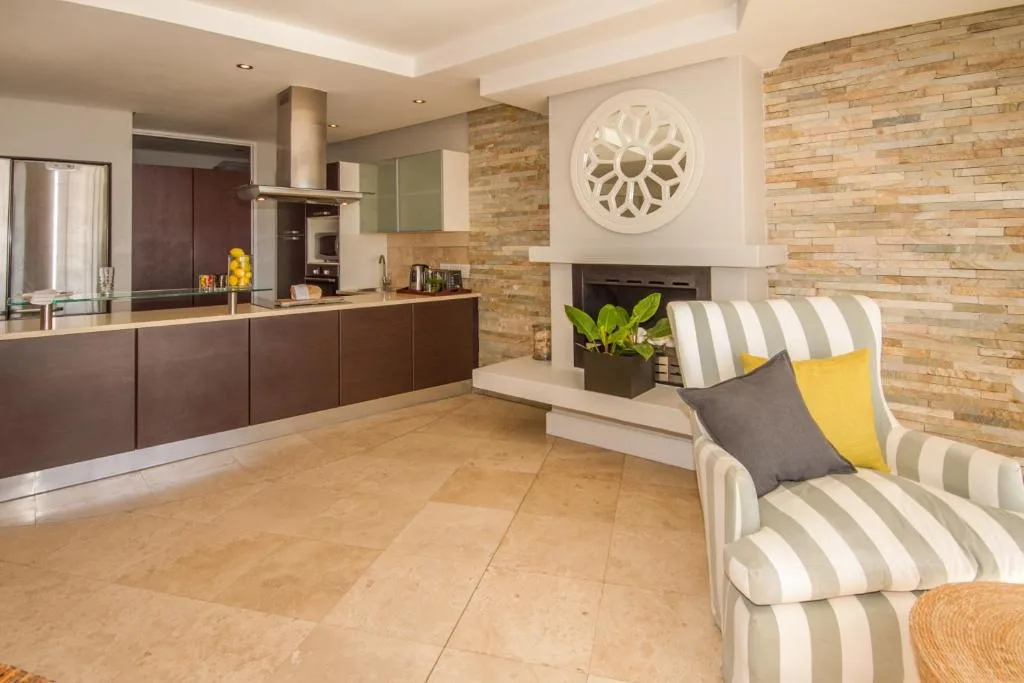 Modern lounge area with striped armchair and brick fireplace feature wall