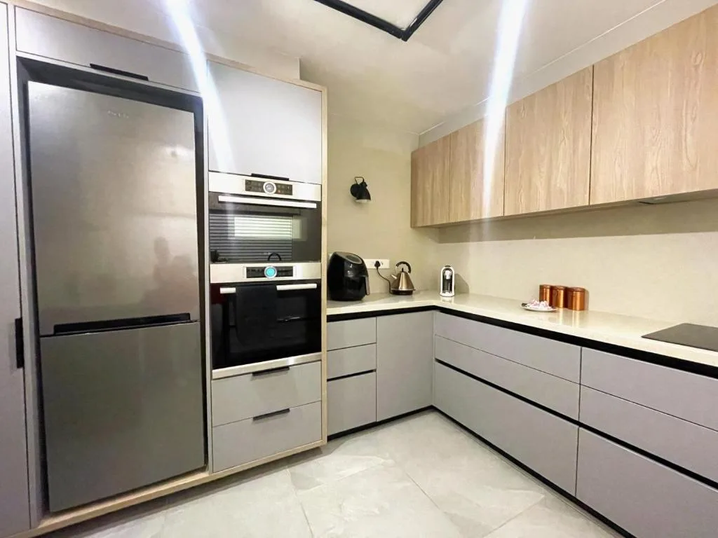 Modern kitchen with stainless steel appliances and light wood cabinetry