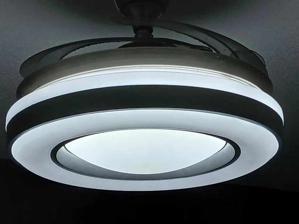 Modern ceiling fan with integrated LED lighting fixture installed indoors