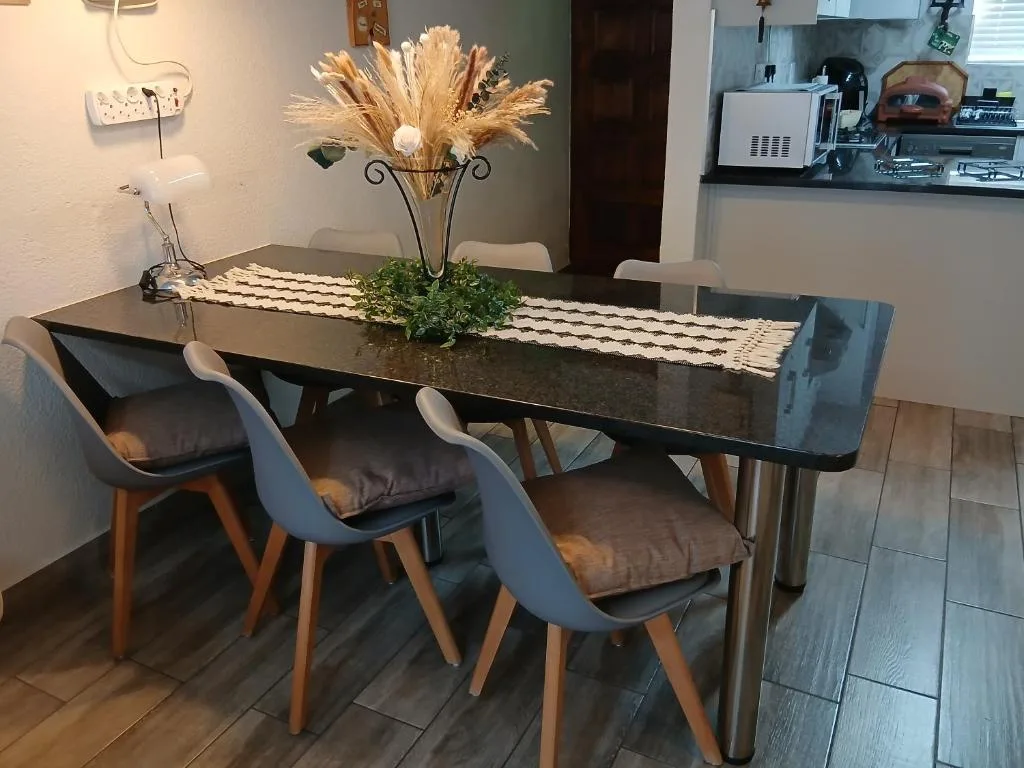 Modern dining table with gray chairs and decorative centerpiece arrangement