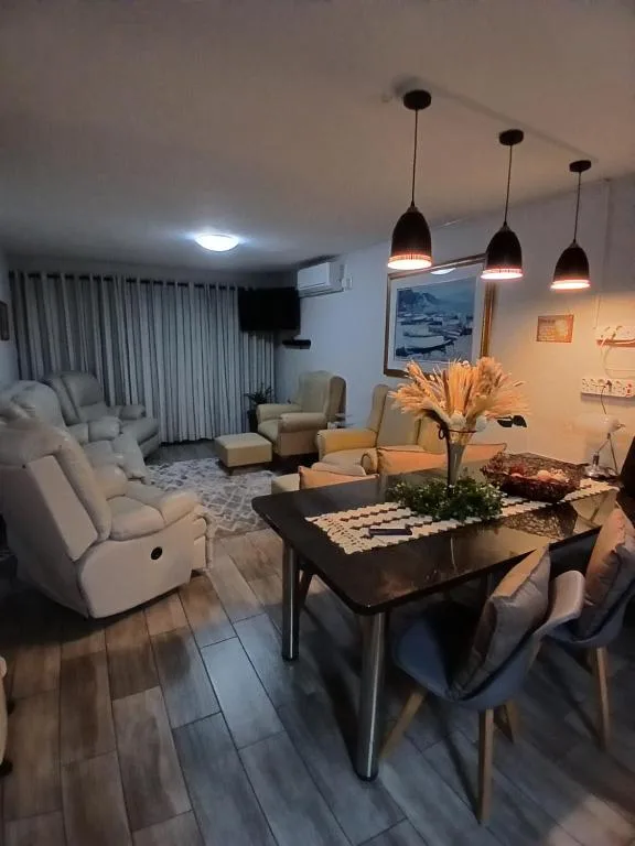 Modern lounge and dining area with comfortable seating and pendant lighting