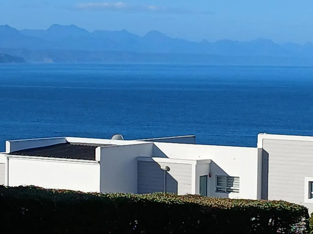 Stunning ocean view with distant mountains across blue water horizon