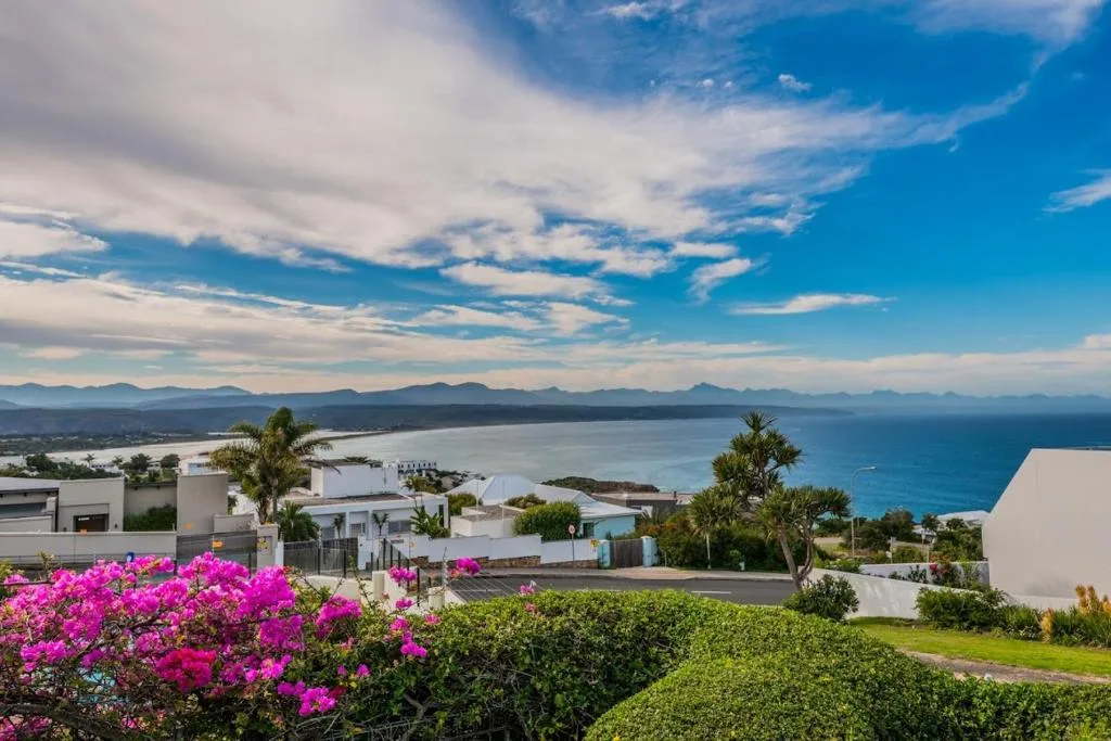 Panoramic coastal view of Plettenberg Bay lagoon with mountains and ocean beyond