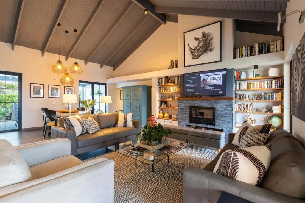 Modern lounge with gray sofas, fireplace, and built-in bookshelves