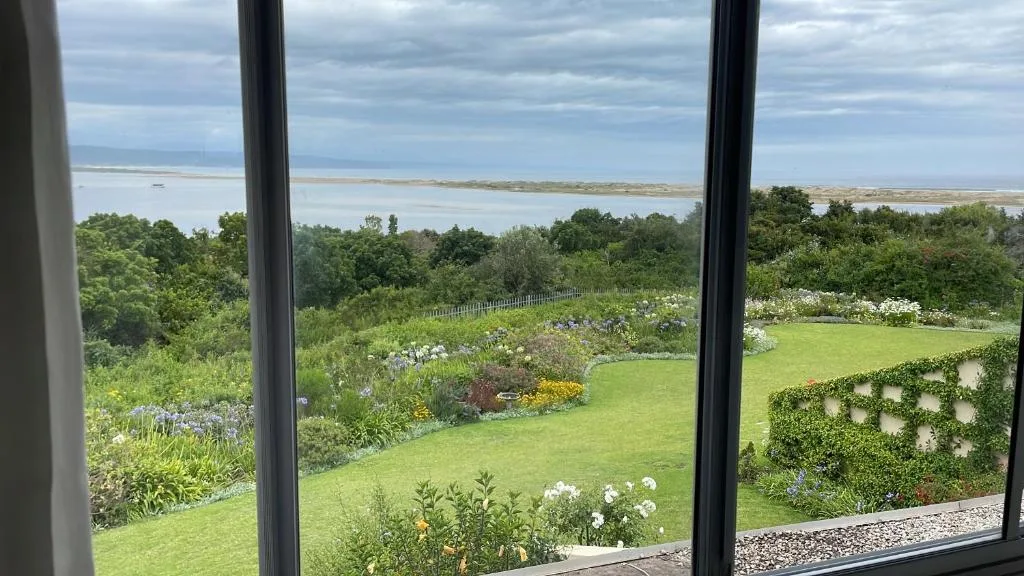 Expansive lagoon and coastal landscape viewed through large windows