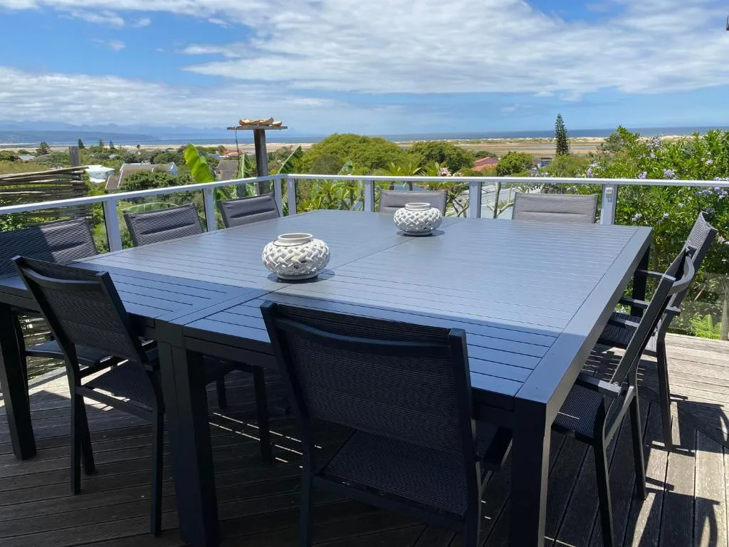 Elevated outdoor dining deck with panoramic view of coastal landscape