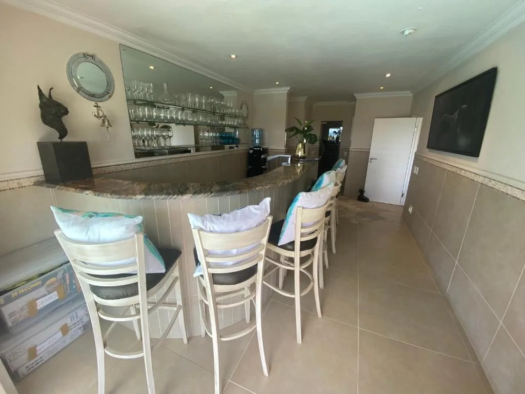 Modern lounge with bar counter, high seating, and entertainment setup