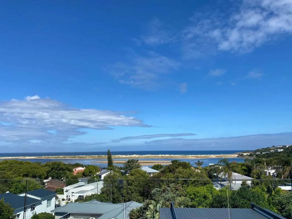 Panoramic lagoon and coastal vista with mountains in distance