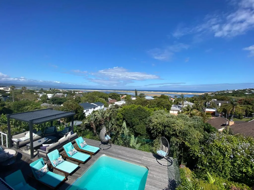 Panoramic coastal landscape with lagoon, ocean, and mountains beyond