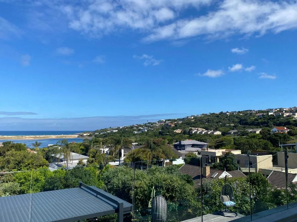 Coastal vista overlooking Plettenberg Bay with lagoon, beaches, and hillside homes