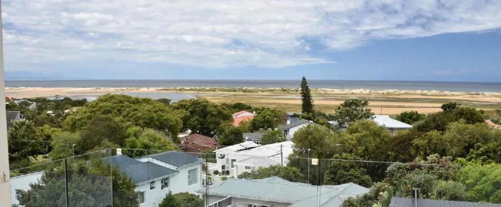 Coastal lagoon and valley landscape stretching to the ocean horizon