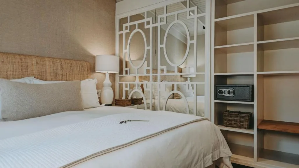 Modern bedroom with queen bed, woven headboard, and built-in shelving