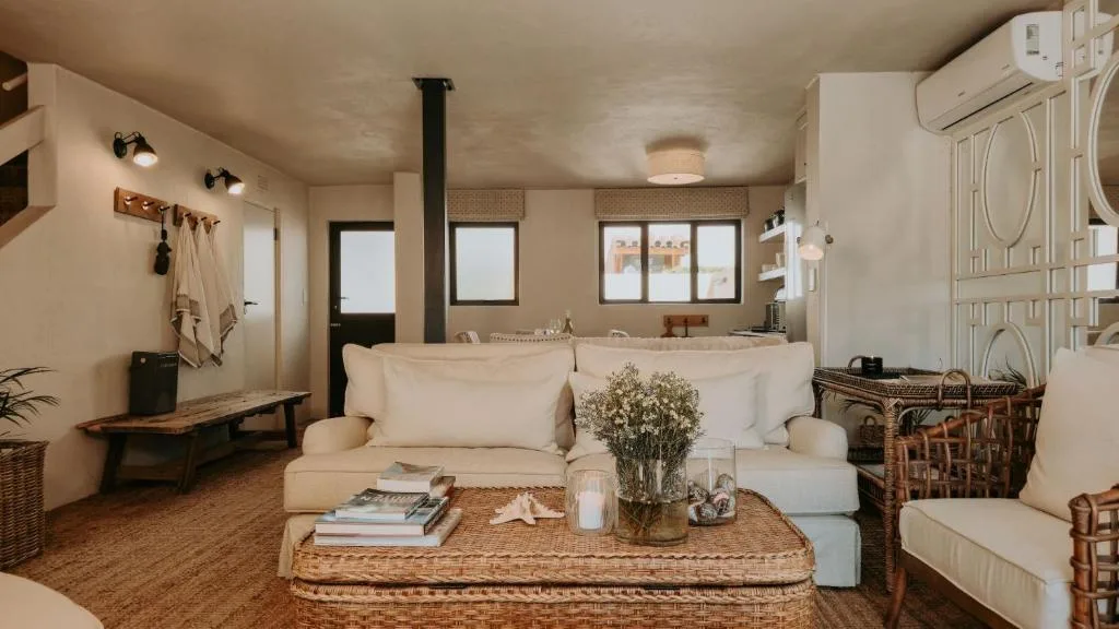 Bright lounge with cream sofa, wicker coffee table, and modern furnishings