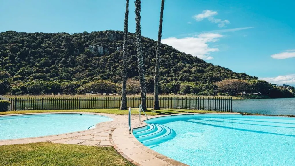 Sparkling swimming pool with mountain and lagoon views behind