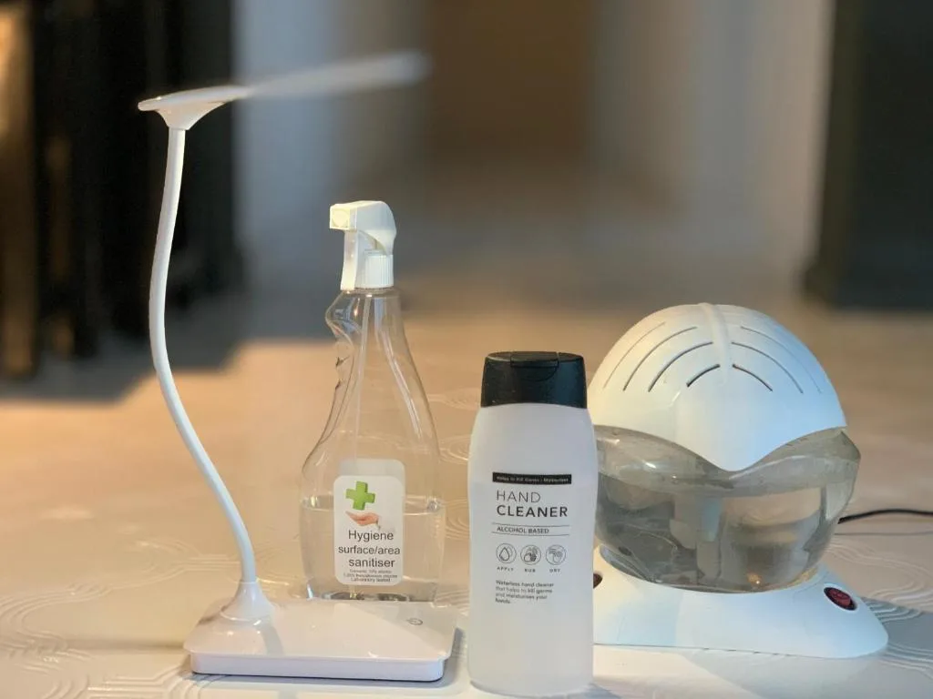 Hand sanitizer, surface cleaner, and humidifier on accommodation table