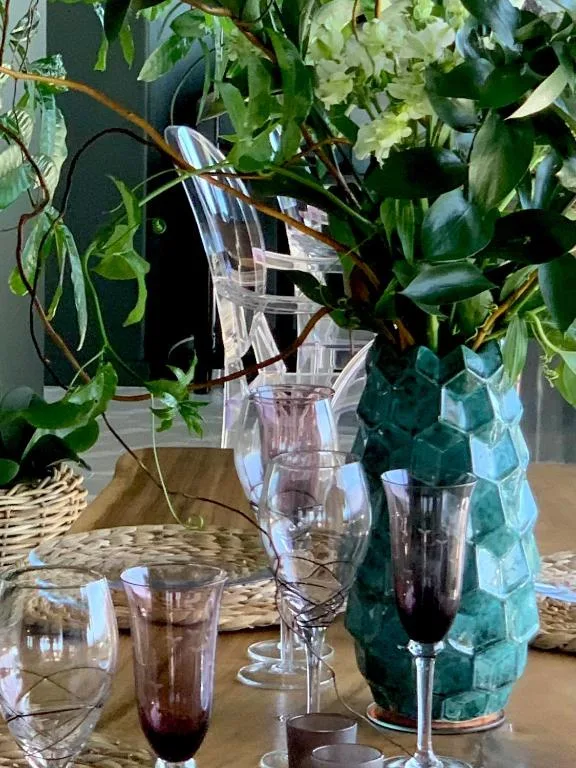 Decorative table styling with fresh flowers and beverage glasses indoors