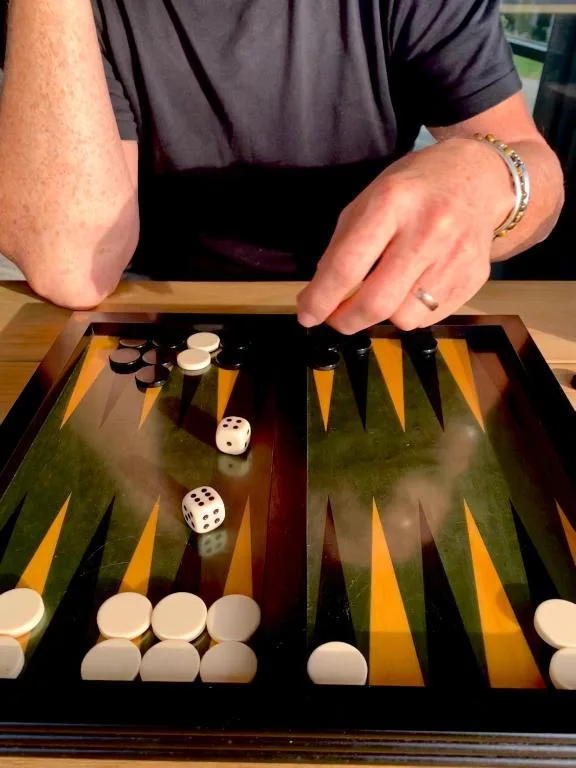 Close-up of backgammon board game with dice and pieces in play
