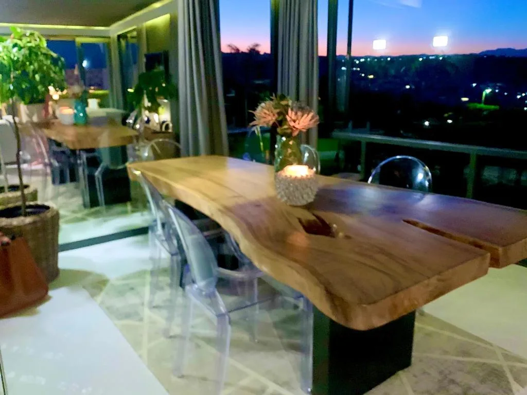 Evening twilight vista over Plettenberg Bay from modern dining area with lights