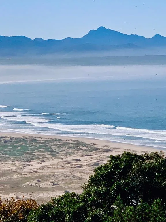Pristine beach with mountains and ocean vista from property