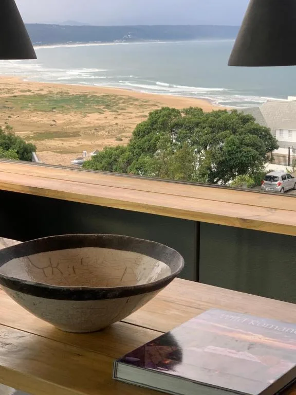 Coastal vista of beach and ocean from interior window overlook