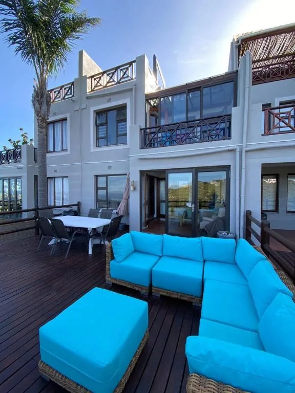 Spacious outdoor deck with bright blue seating and mountain views