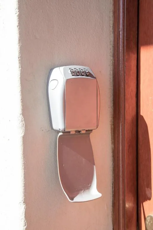 Wall-mounted keypad entry lock on terracotta exterior wall