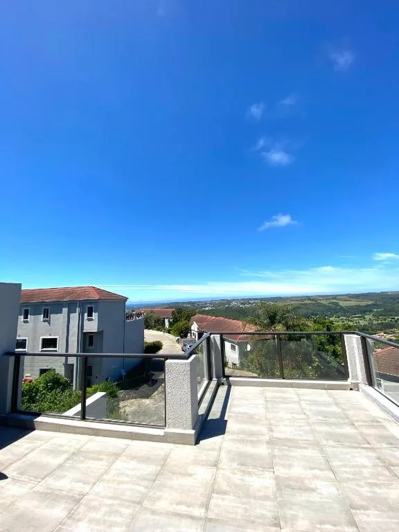 Expansive panoramic vista across Plettenberg Bay hills from elevated deck