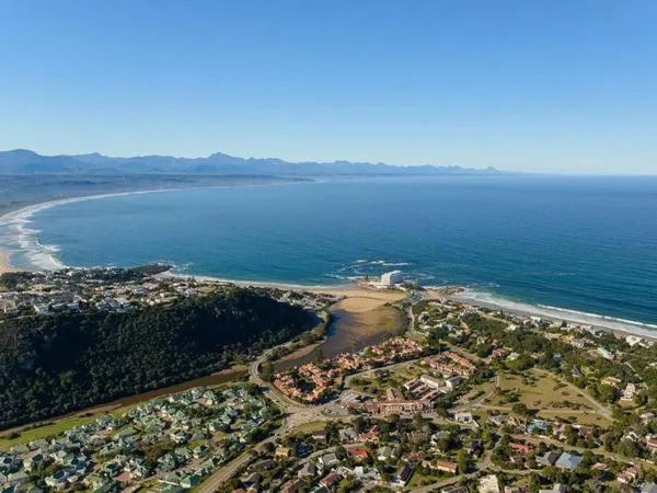 Aerial coastal view of Plettenberg Bay with mountains, lagoon, and beaches