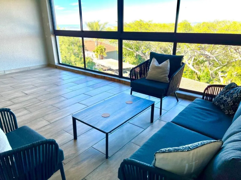 Spacious outdoor deck with comfortable seating and panoramic garden views