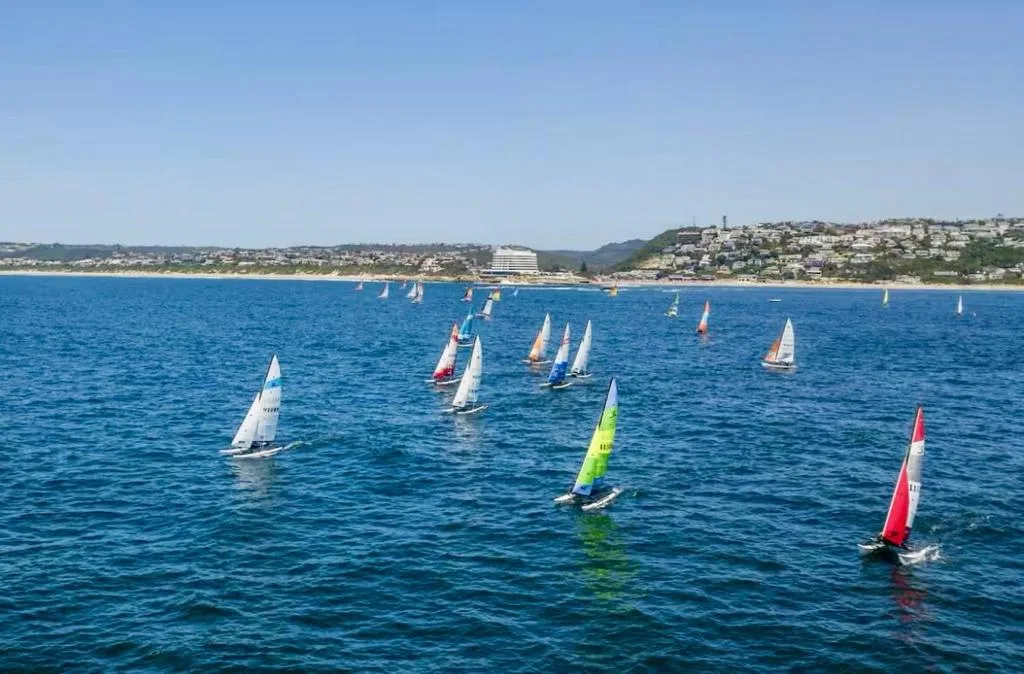 Scenic coastal view of Plettenberg Bay with sailboats and beachfront town