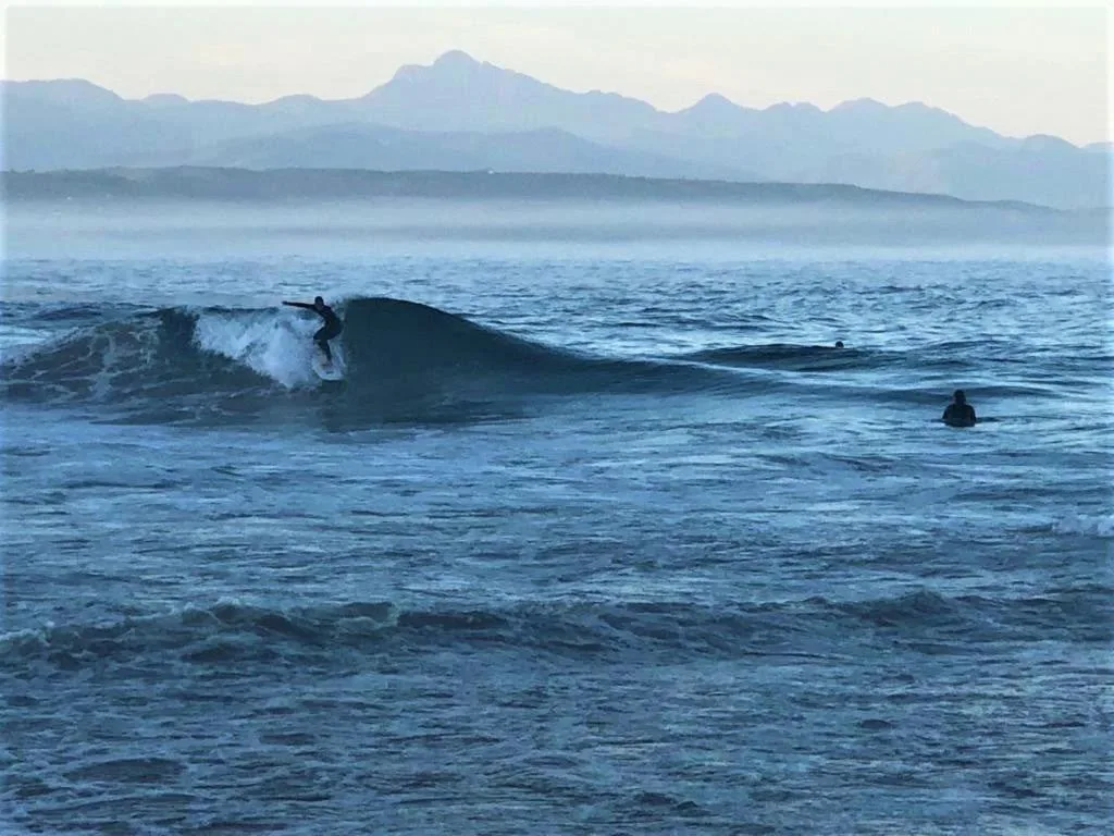 Ocean waves and mountains visible from the property's beachfront location