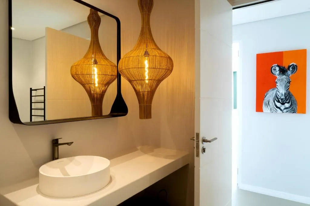 Modern bathroom vanity with vessel sink and decorative pendant lighting