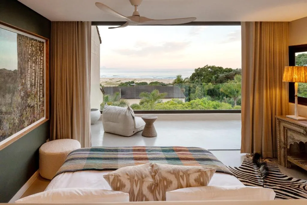 Luxurious bedroom with ocean and lagoon views through large windows