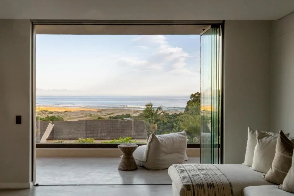 Panoramic ocean and beach vista from bedroom with coastal landscape