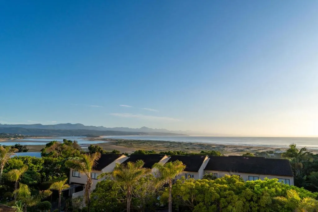 Scenic coastal view of lagoon, mountains, and ocean from elevated vantage point
