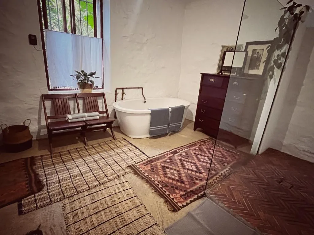 Spacious bathroom with freestanding bathtub and vintage furnishings