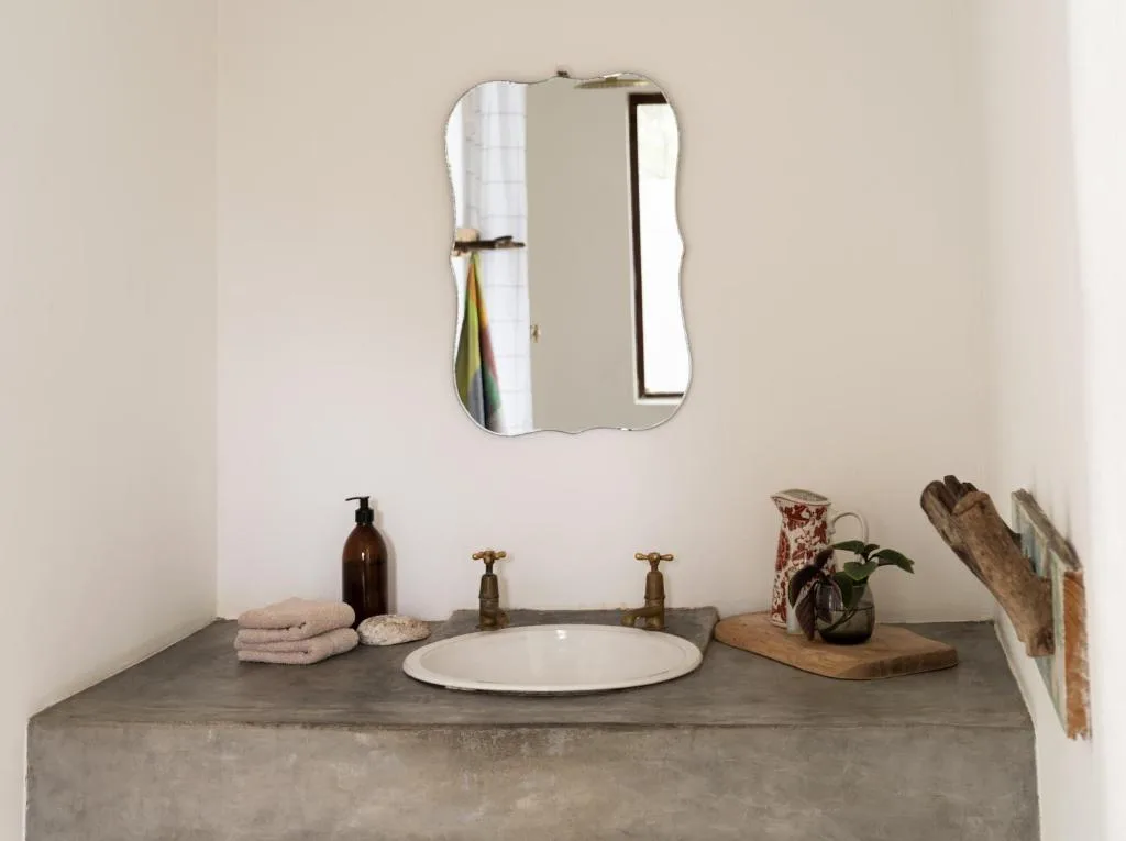 Minimalist bathroom vanity with concrete countertop and round white sink