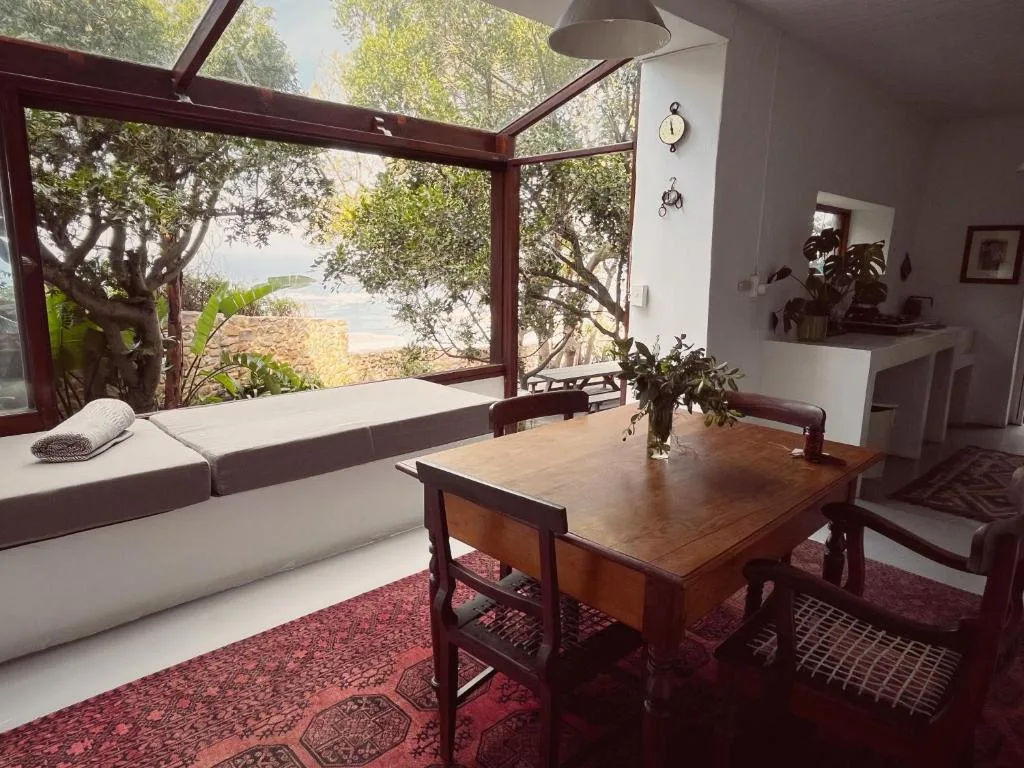 Open-plan lounge and dining area with garden views through large windows