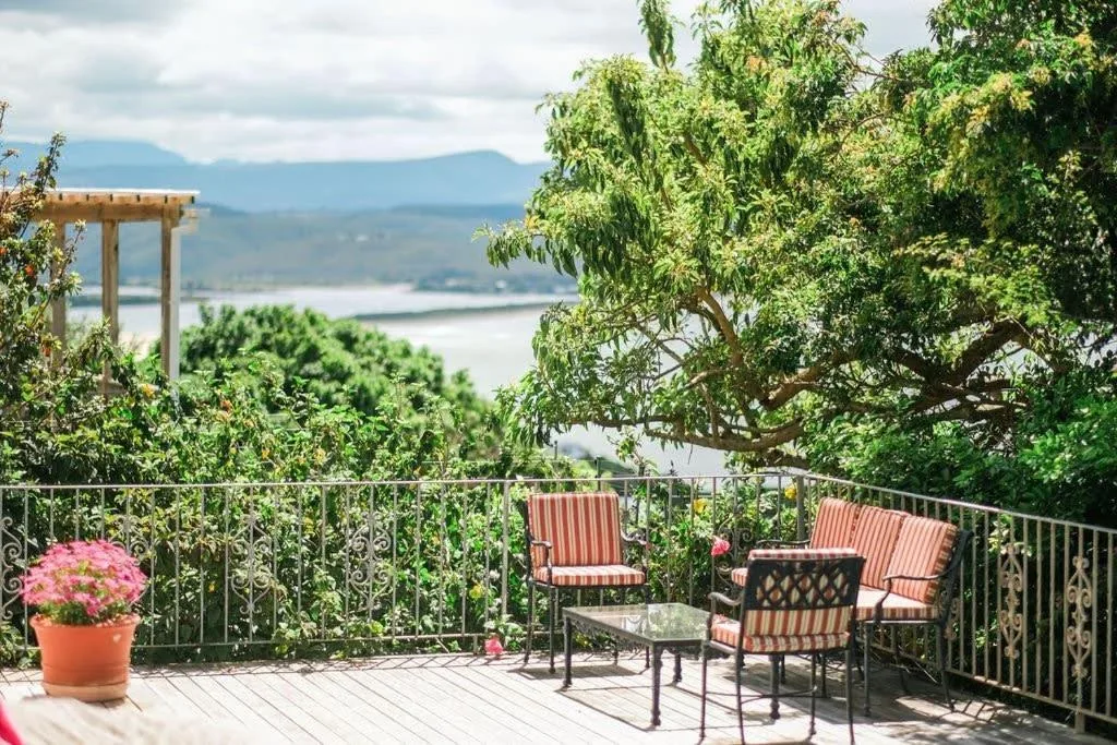 Outdoor patio with seating overlooking lagoon and mountains