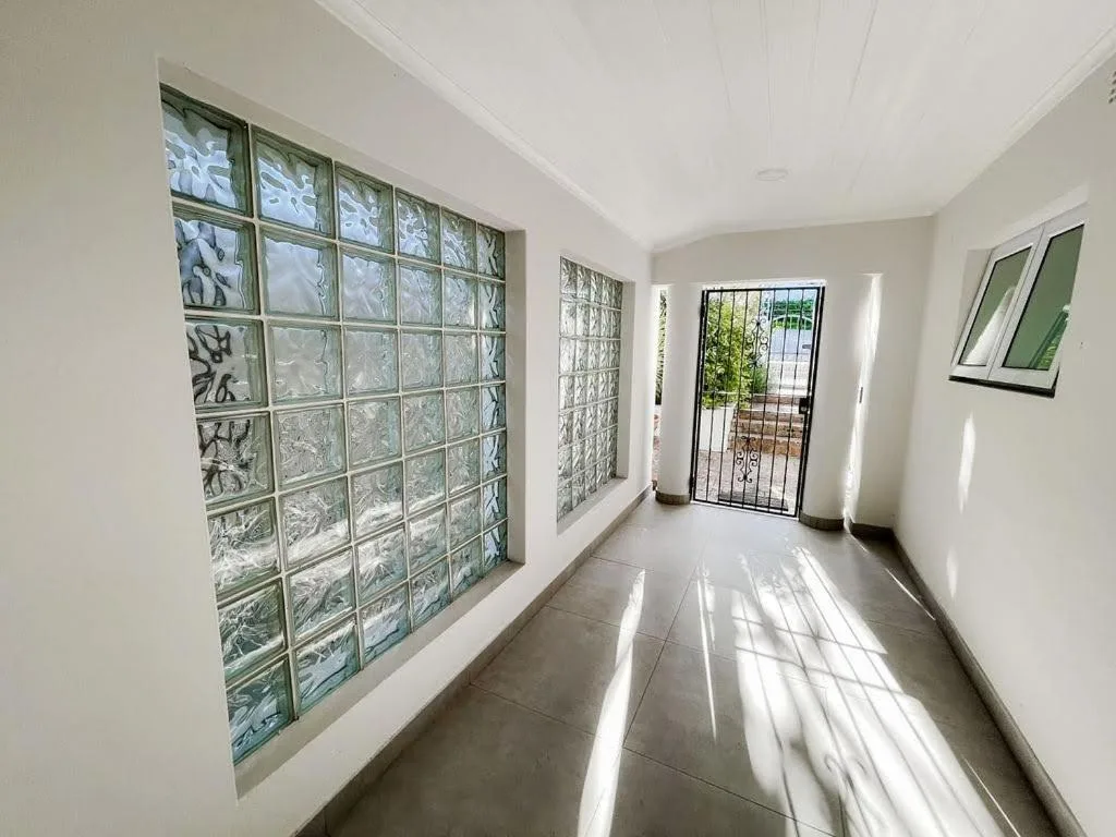 Bright hallway with decorative glass block windows and natural light