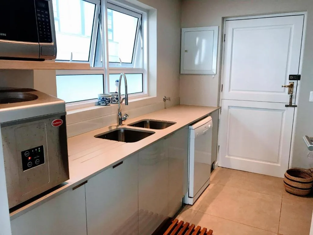 Modern kitchen with stainless steel appliances and dual sink with window view