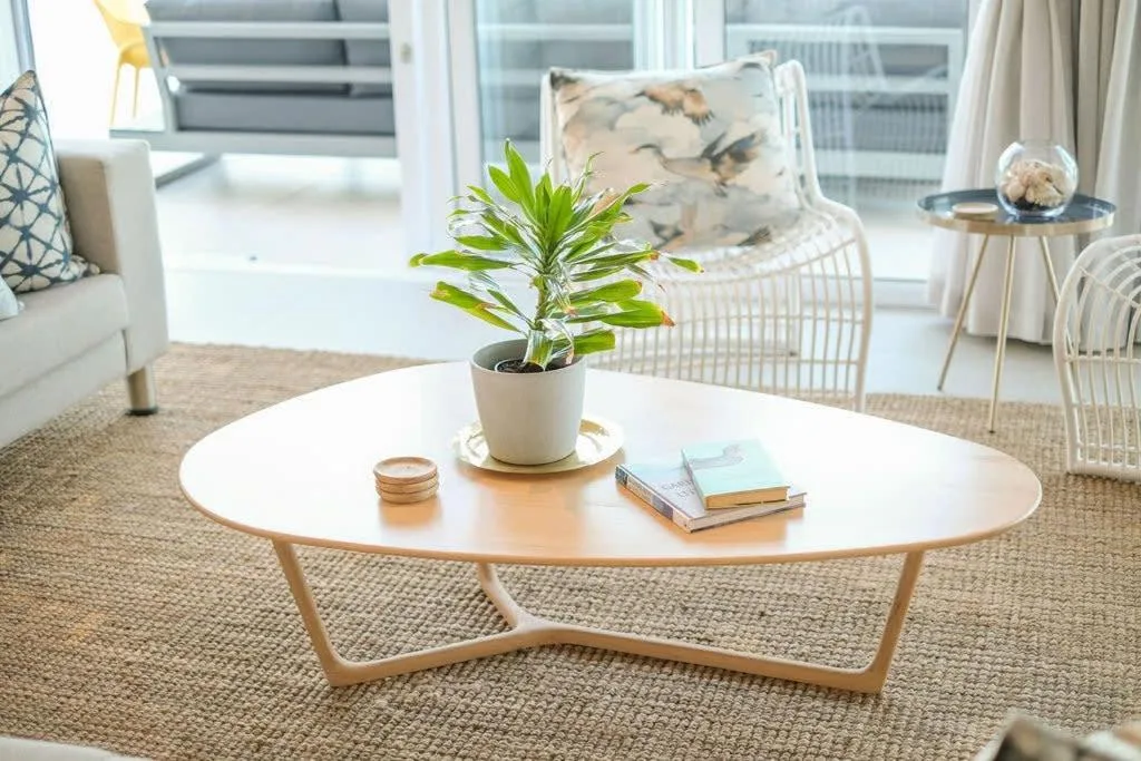Bright modern lounge with round white coffee table and comfortable seating