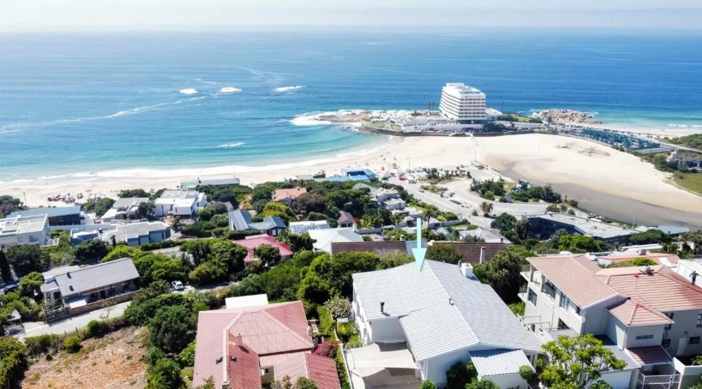 Aerial view of coastal town with pristine beach and sparkling ocean waters