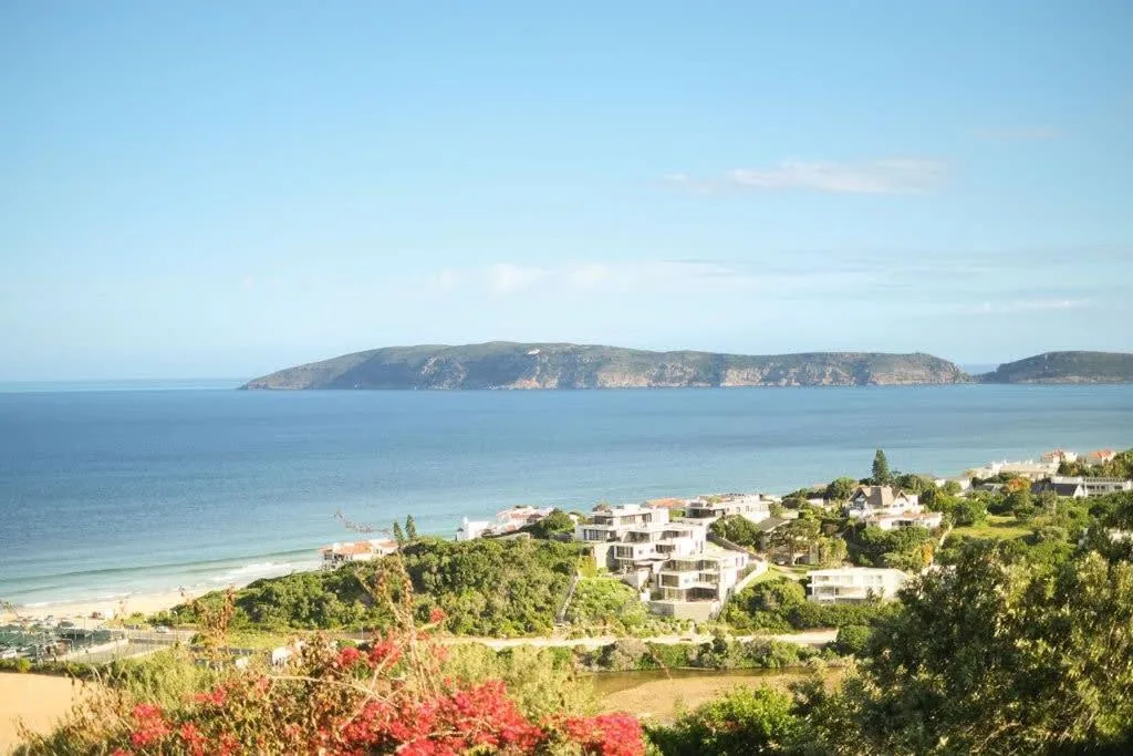 Coastal property overlooking pristine beach and turquoise ocean waters with island vista