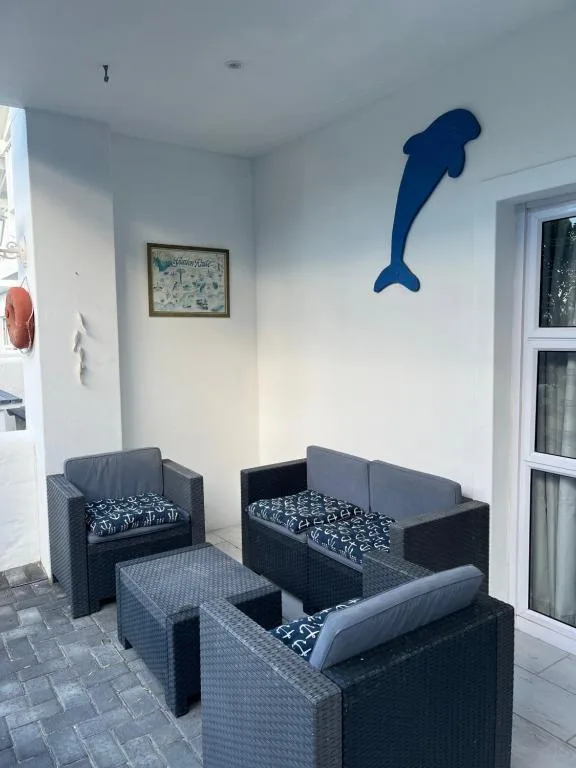 Outdoor seating area with dark wicker furniture and coastal decor